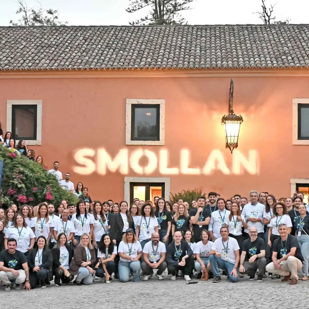 Smollan team gathering with Smollan brand projection celebrating one unified Smollan brand in Europe