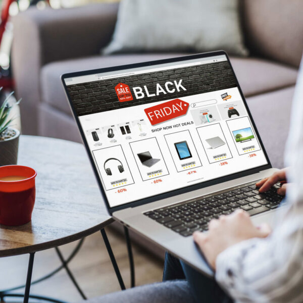 Shopper browsing an eCommerce website with promotional product listings on a laptop