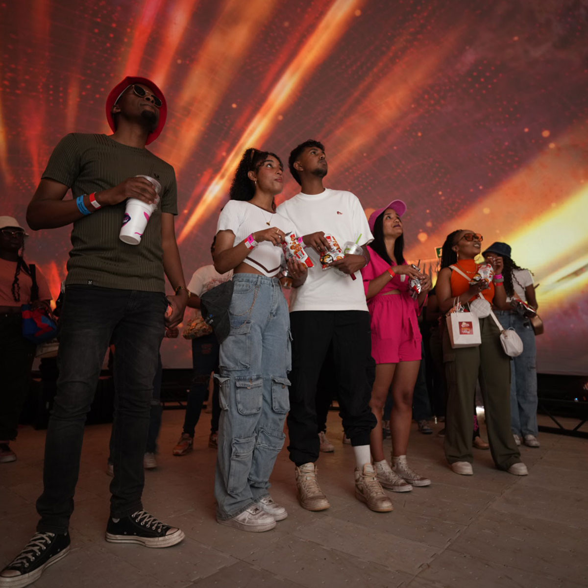 Consumers engaging with an immersive digital brand experience at a live activation event
