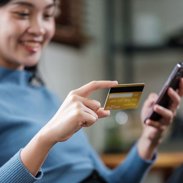 Shopper making an online purchase on a smartphone using a credit card
