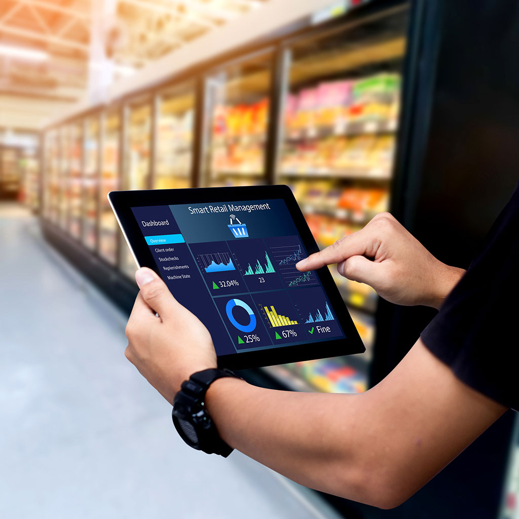 Retail worker using a tablet with analytics dashboard to monitor store execution and performance
