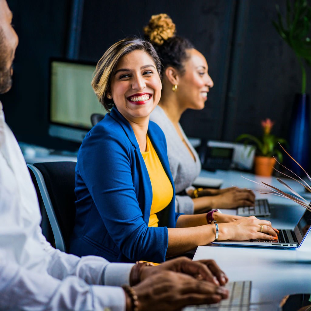 Colleagues working together at computers in a modern office environment