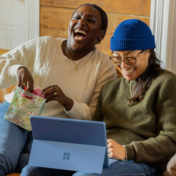 Consumers engaging with digital content on a tablet, representing performance marketing and online conversion