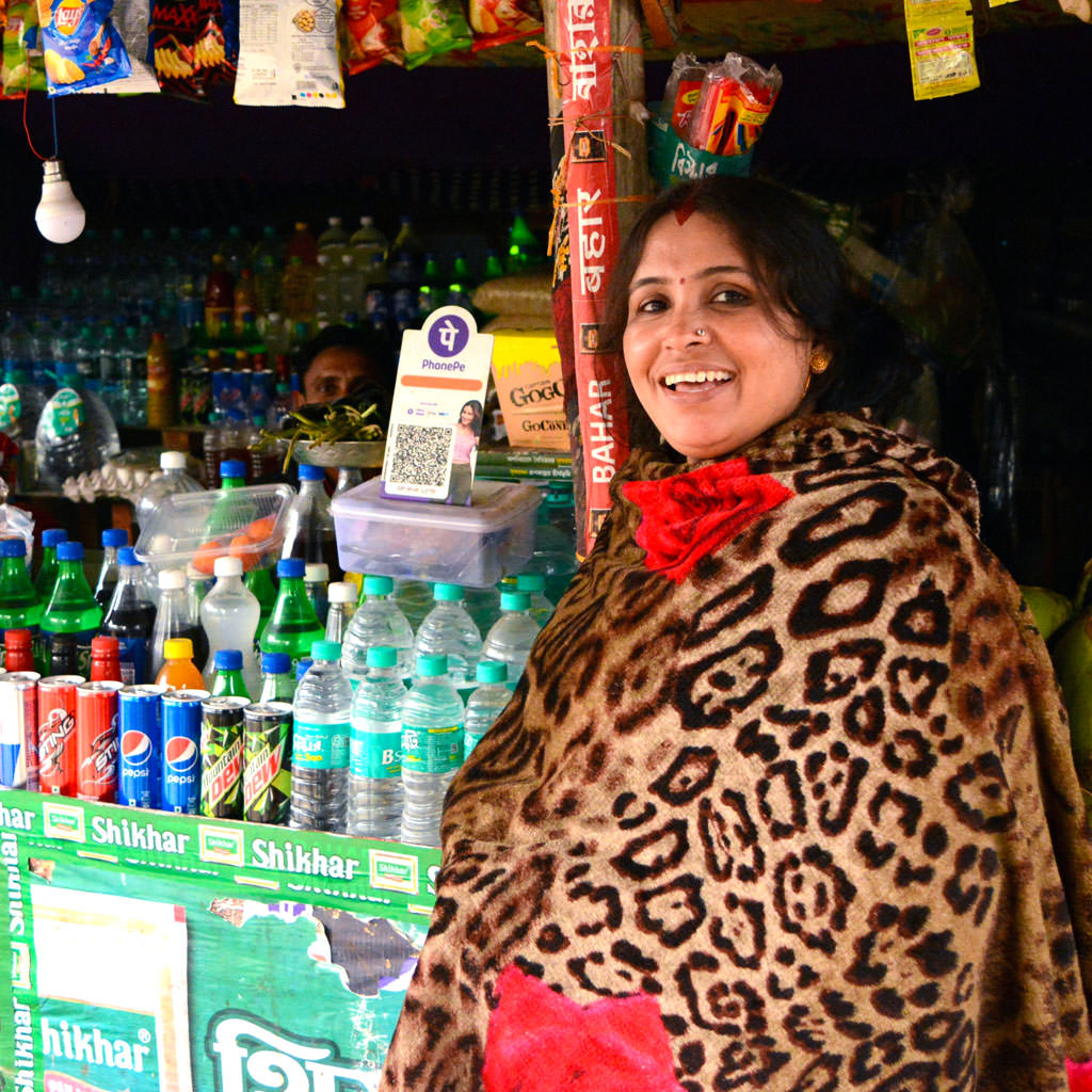 Small retail shop displaying beverages and point-of-sale branding at the checkout counter