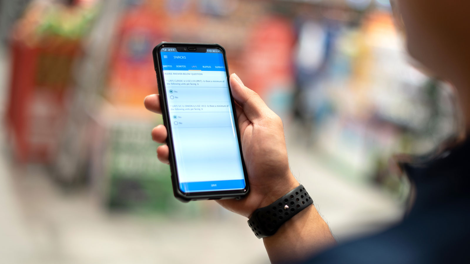 Person using a smartphone to capture retail data in store