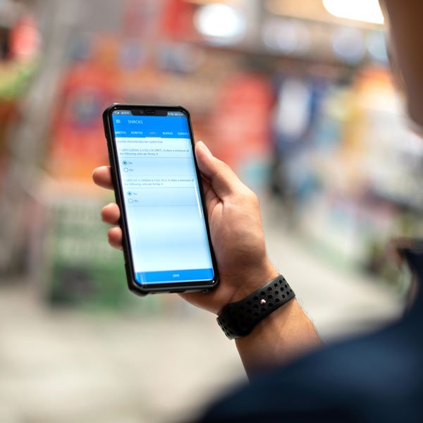 Person using a smartphone to capture retail data in store