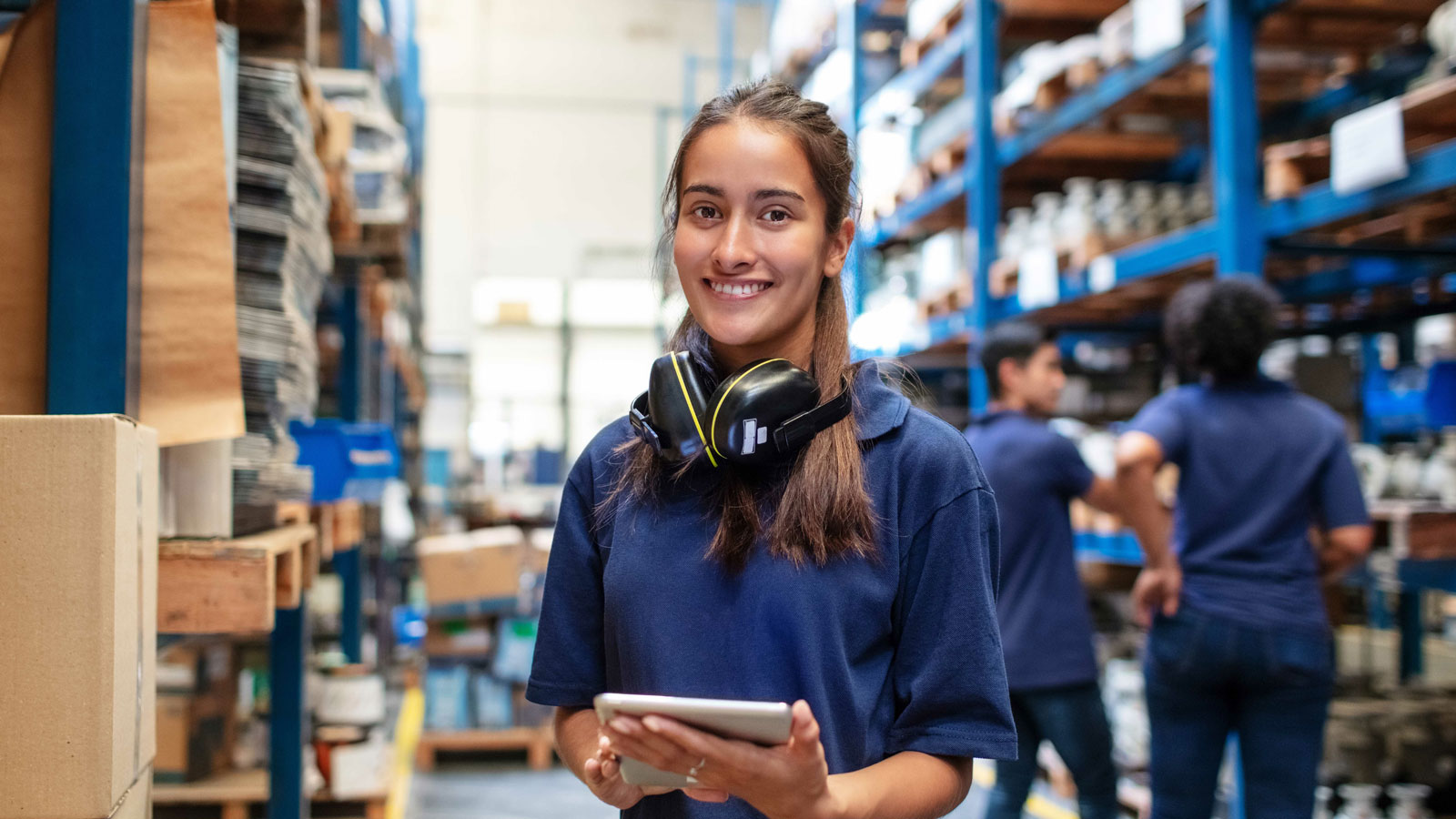 Warehouse worker holding a tablet in a distribution centre