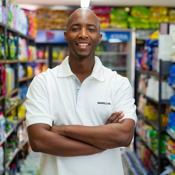 A sales person lookingh into the camera with his arms folded